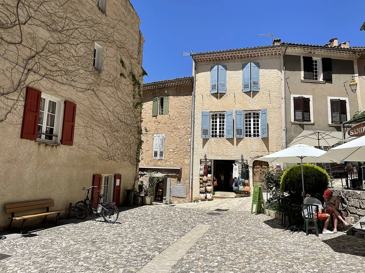 Une place et les façades du village de Moustiers-Sainte-Marie.